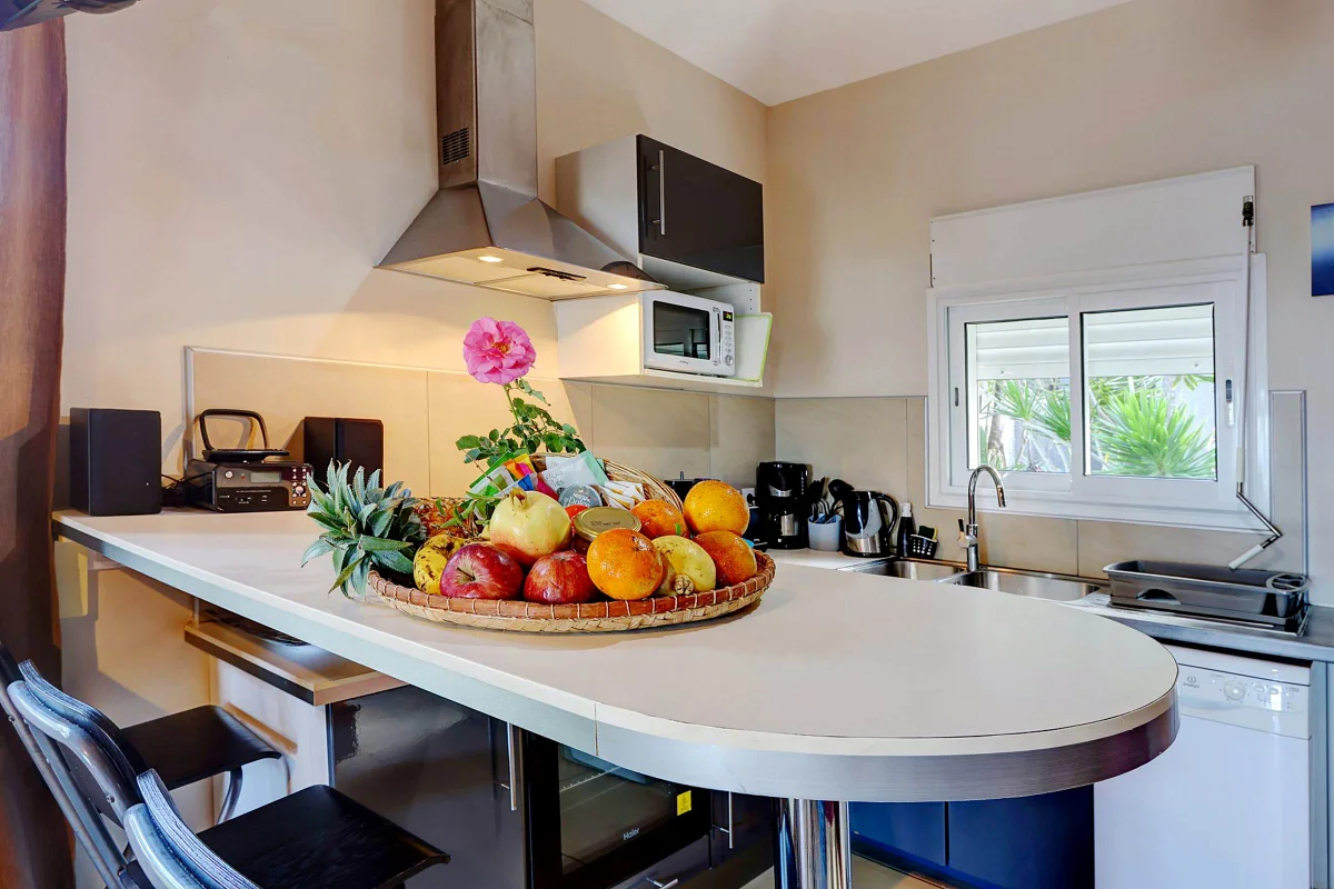 La cuisine de la villa 3 chambres, son comptoir et sa corbeille de fruits